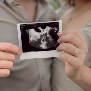 Couple sharing their baby scan outdoors