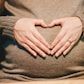 Heart hands on pregnant belly